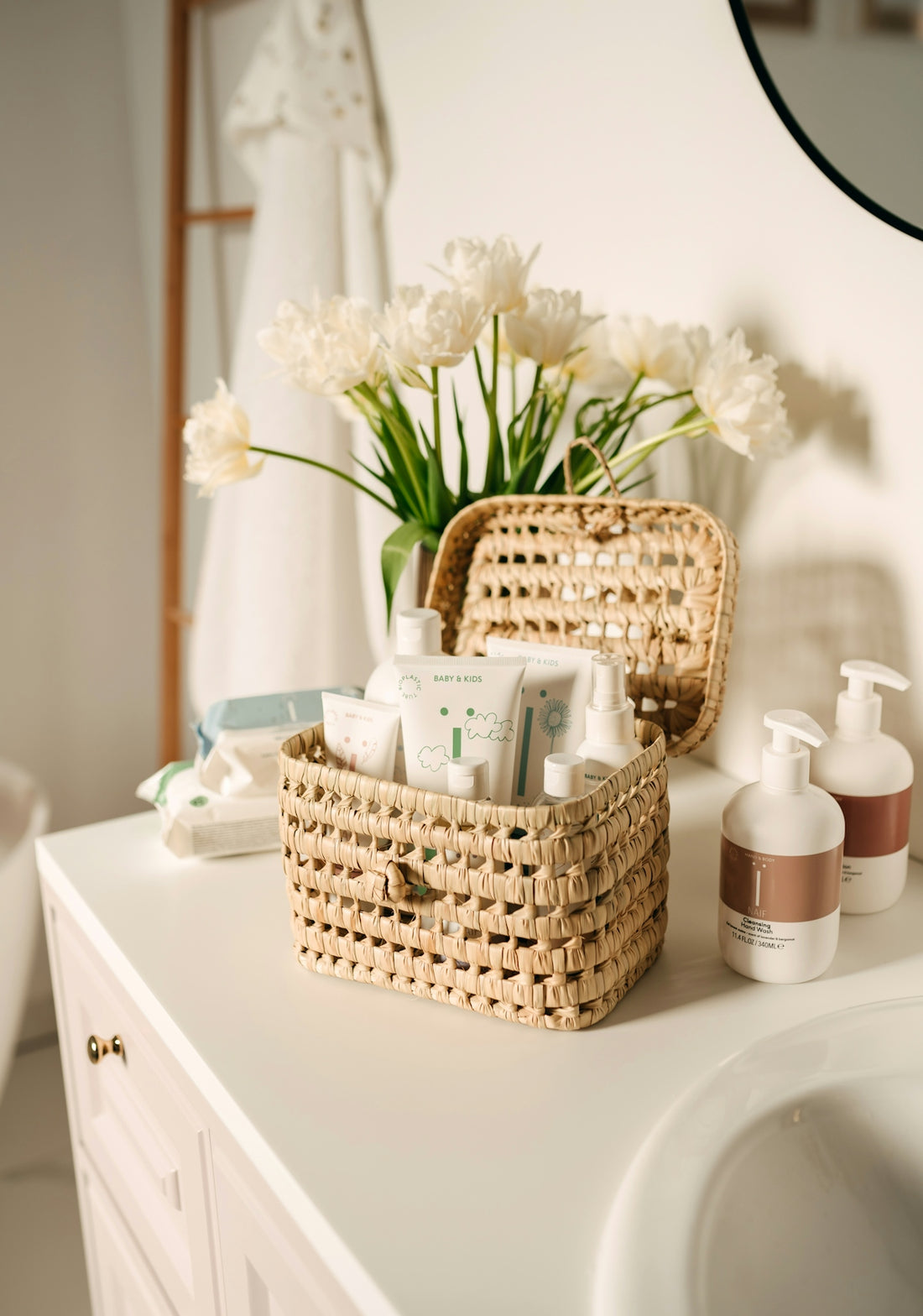 a wicker basket on a bathroom counter next to a sink