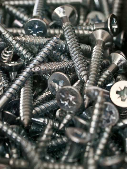 a bunch of screws and nuts in a pile