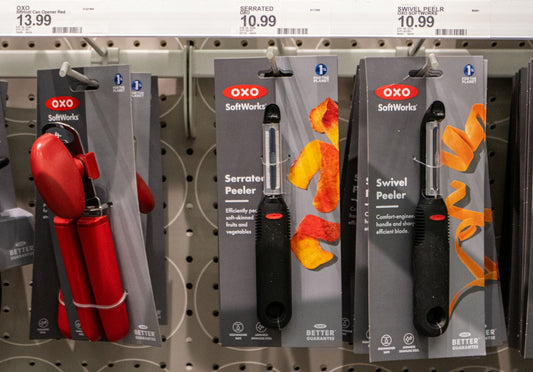 Kitchen tools are displayed on a store shelf.