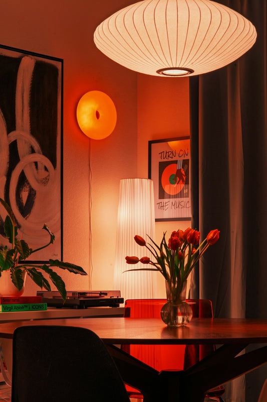 A cozy room with warm lighting and flowers.