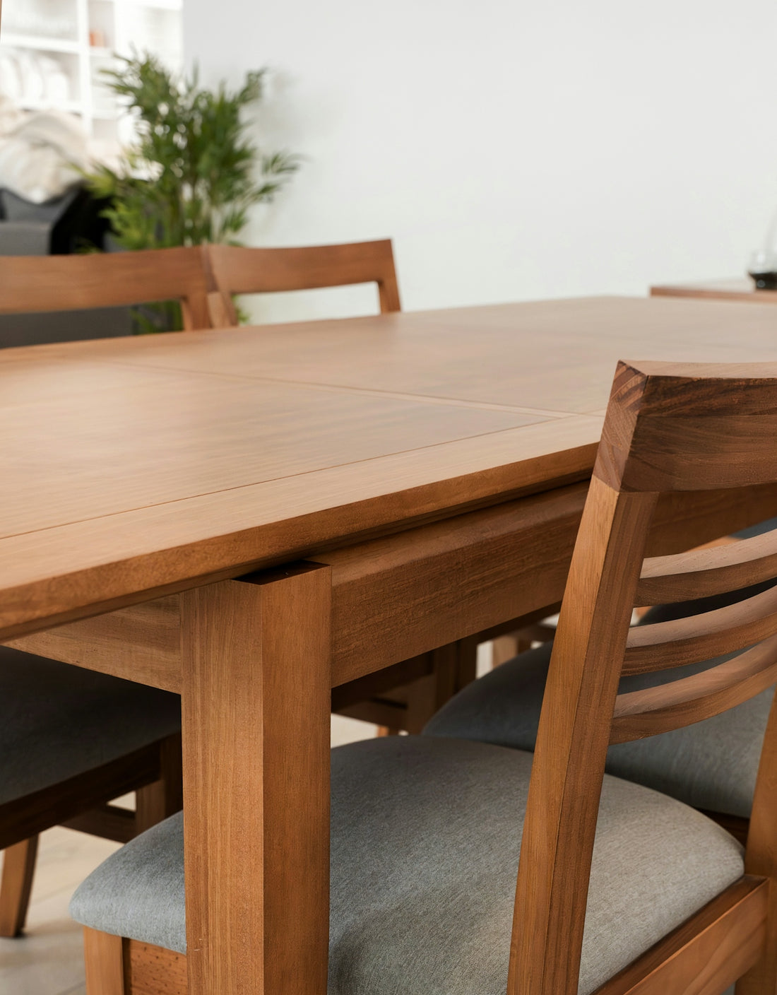 A wooden dining table with upholstered chairs.