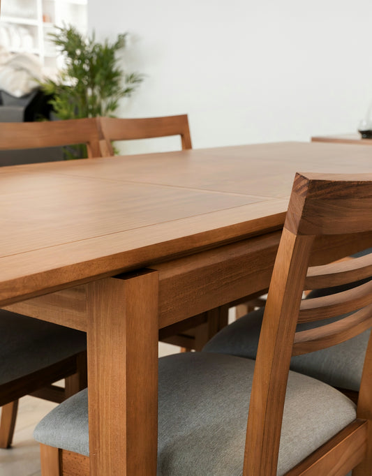 A wooden dining table with upholstered chairs.
