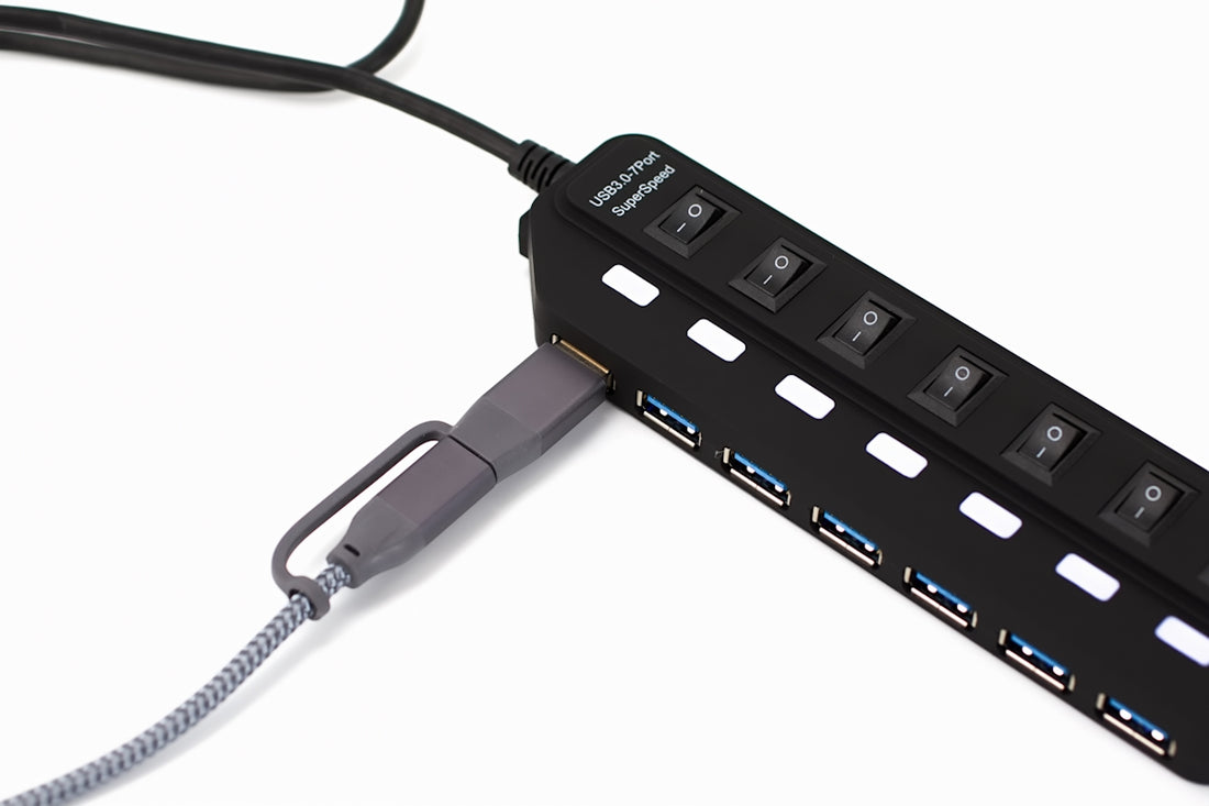 Black usb hub with multiple ports and switches.