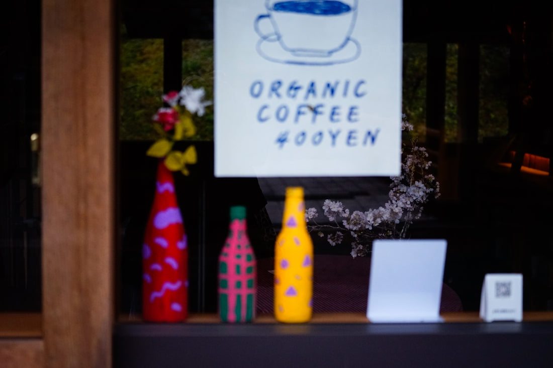 Organic coffee sign with colorful bottles in window