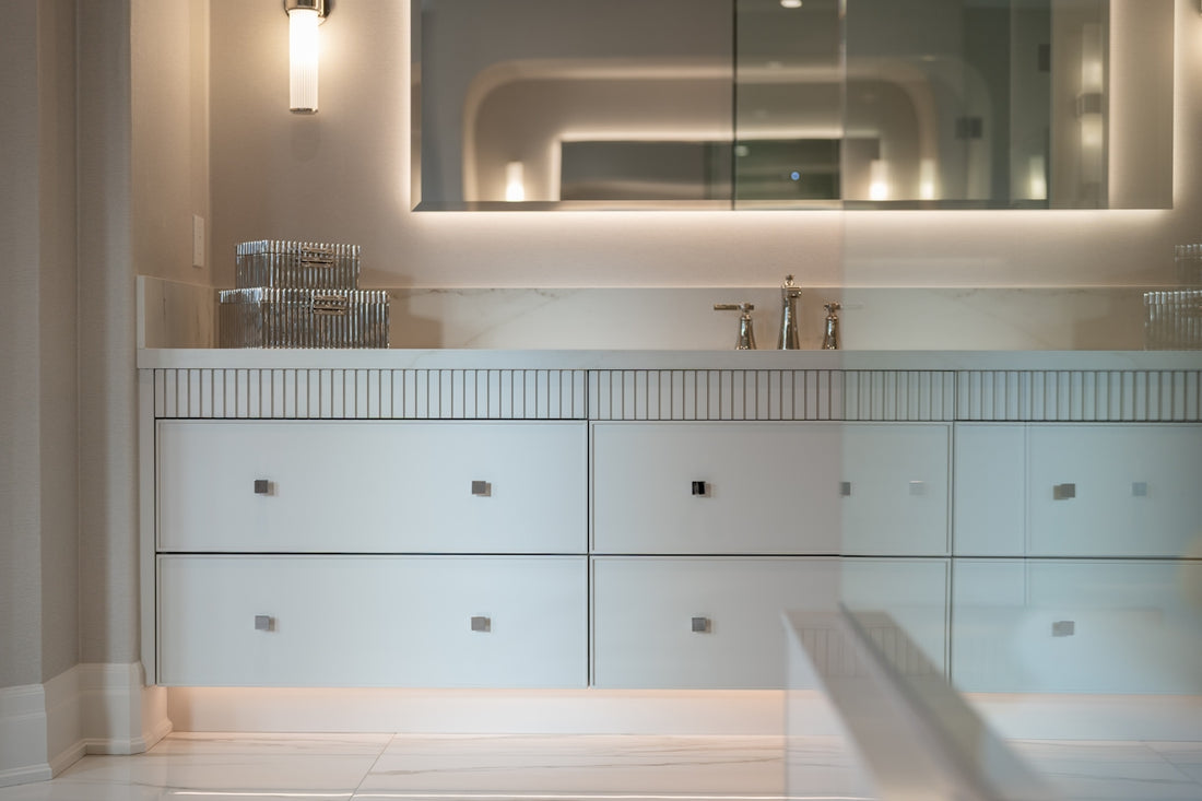 Modern bathroom vanity with sink, mirror, and illuminated lighting.