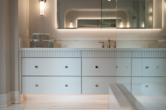 Modern bathroom vanity with sink, mirror, and illuminated lighting.