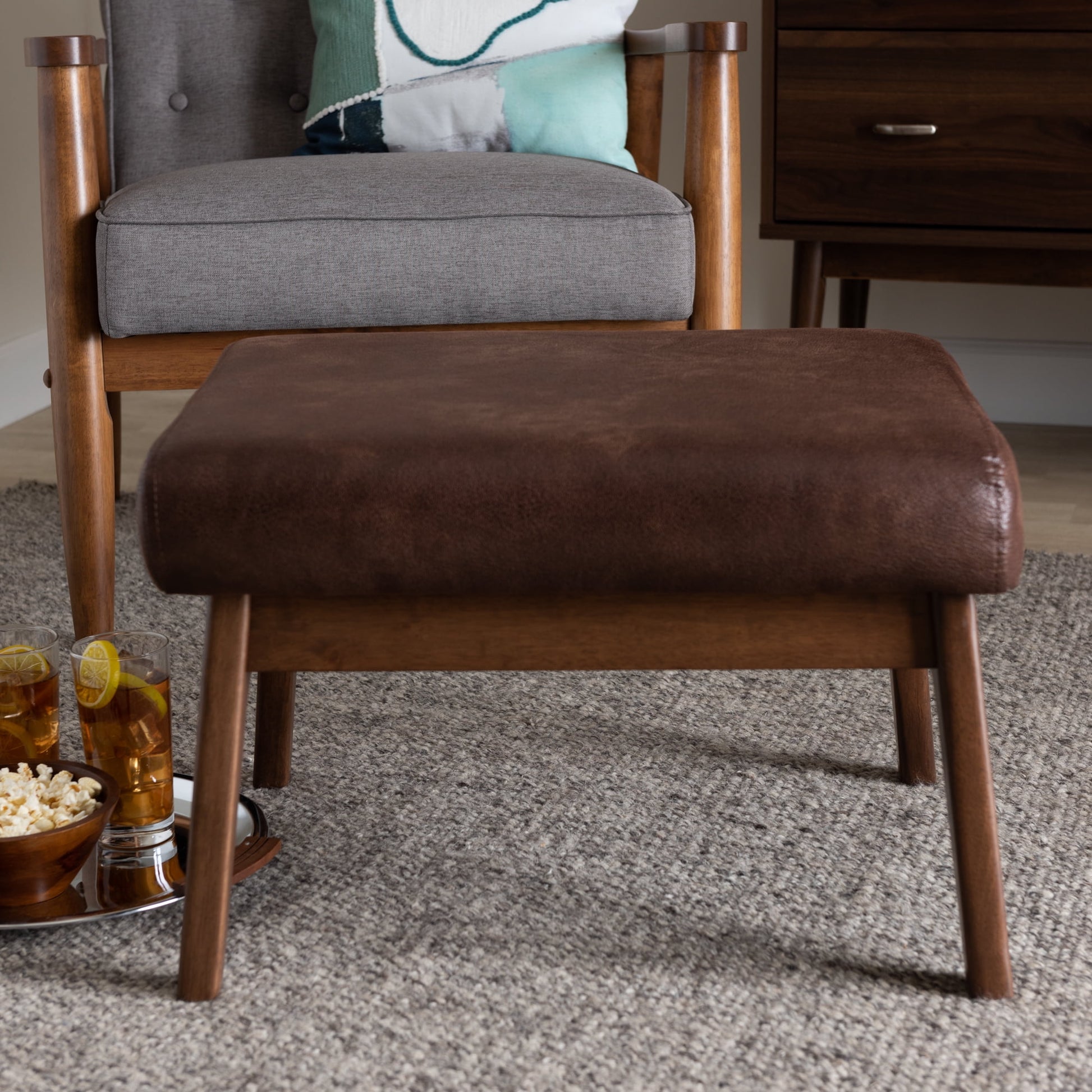 Bakari Mid-Century Modern Walnut Wood Dark Brown Distressed Faux Leather Ottoman by Bellamy Studios